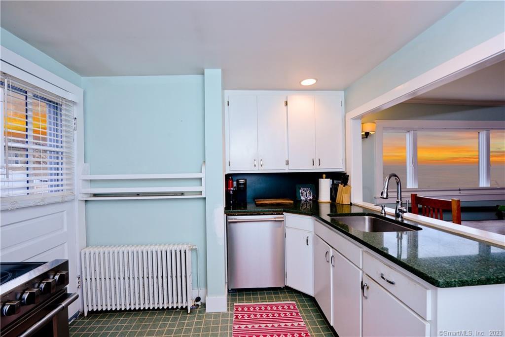 20 Omega Street Stonington, CT 06378 - Photo 17 of 37 a kitchen with a sink stove and cabinets
