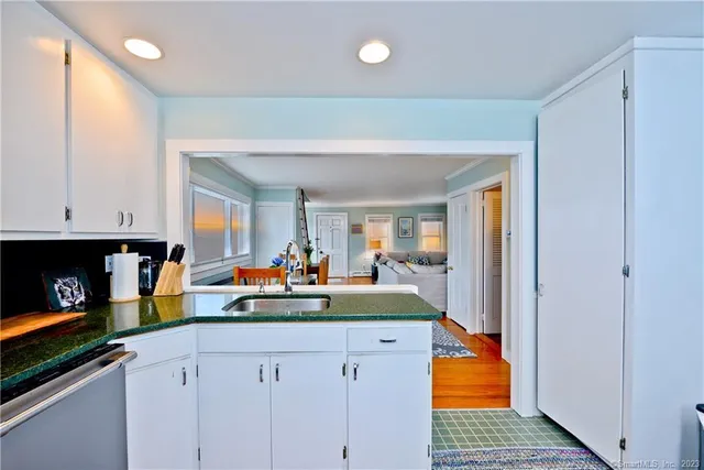 a kitchen with stainless steel appliances granite countertop a sink dishwasher stove and cabinets