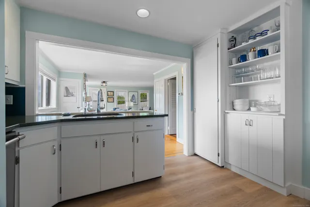 a kitchen with cabinets and chairs
