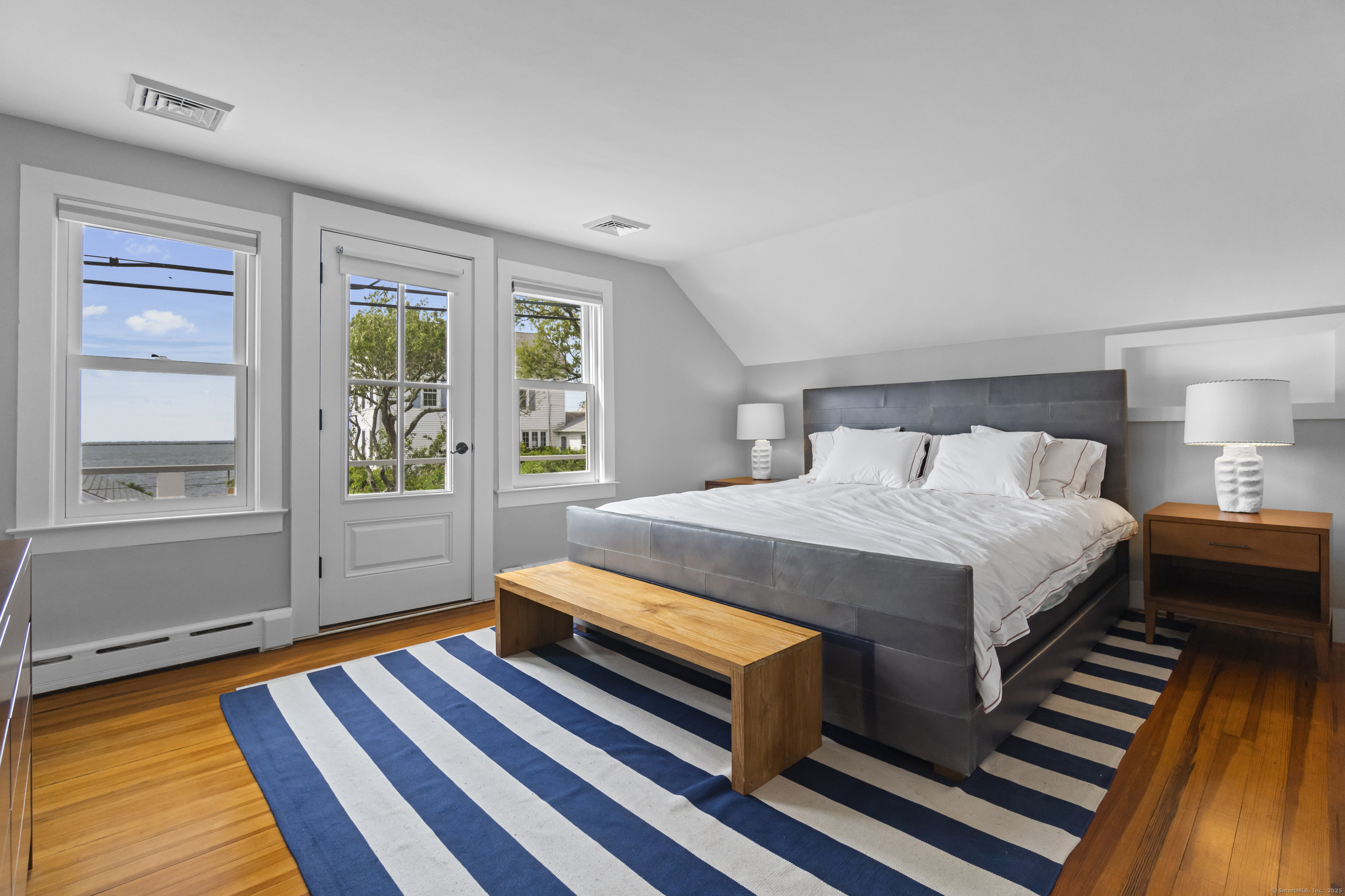 20 Omega Street Stonington, CT 06378 - Photo 24 of 37 a bed sitting in a bedroom next to a window