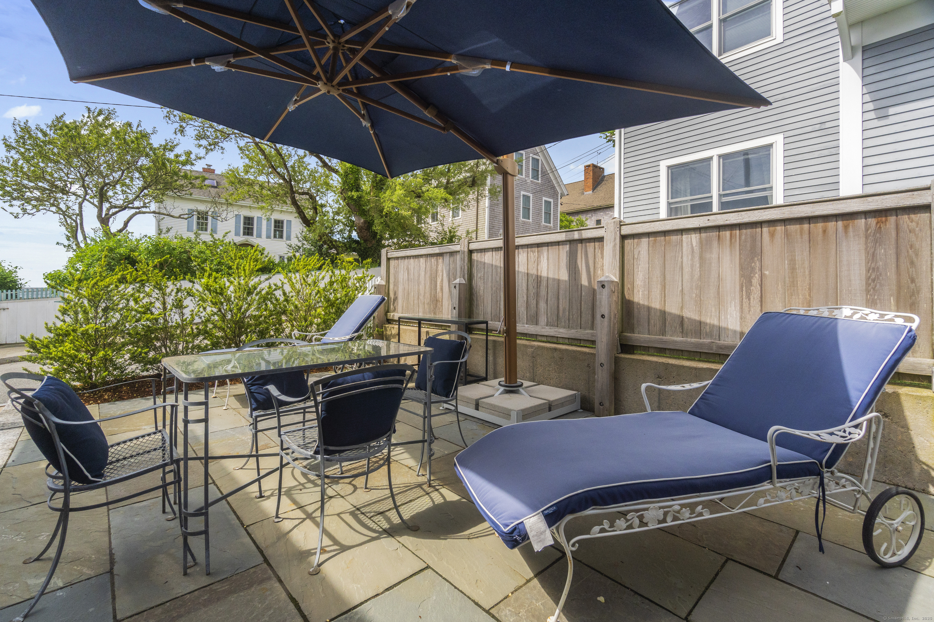 20 Omega Street Stonington, CT 06378 - Photo 32 of 37 a view of a patio with table and chairs under an umbrella