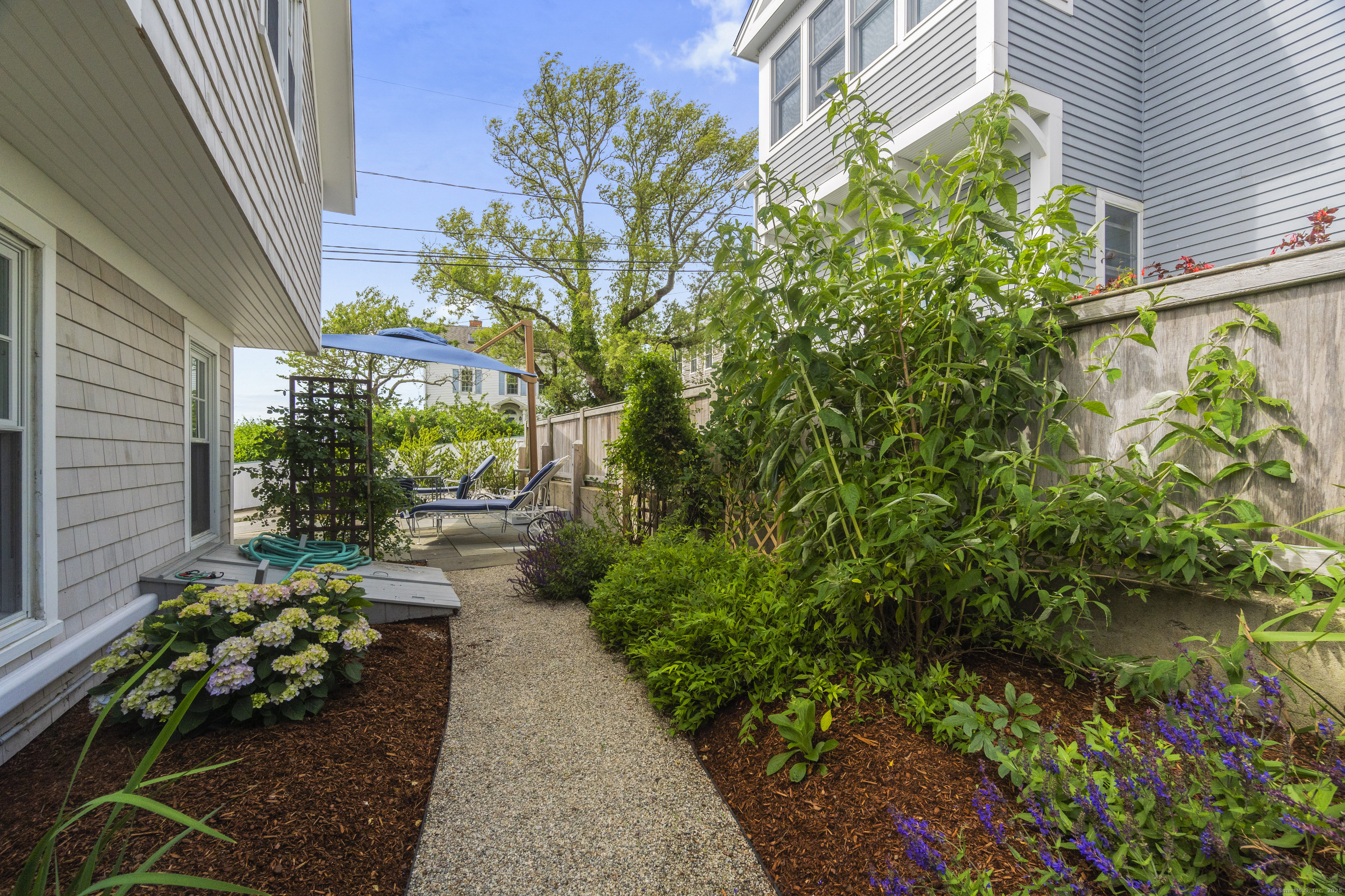 20 Omega Street Stonington, CT 06378 - Photo 33 of 37 a lots of flowers in front of a house