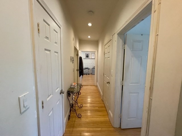 1793 Beacon Street, Unit 3 Brookline, MA 02445 - Photo 12 of 25 a view of a hallway with a couch and a door in a corridor