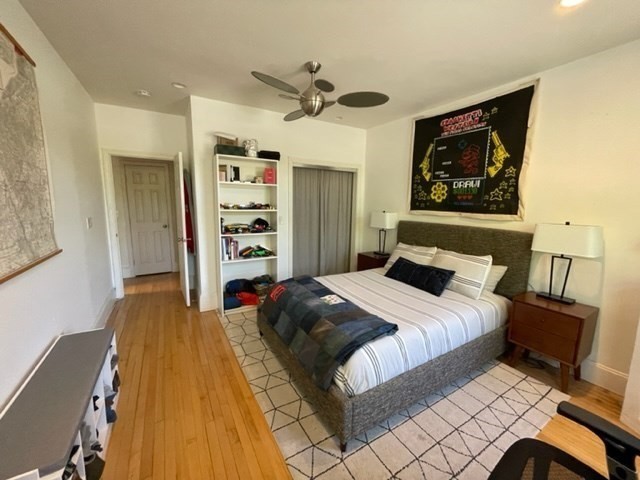 1793 Beacon Street, Unit 3 Brookline, MA 02445 - Photo 13 of 25 a bedroom with a bed and a chandelier