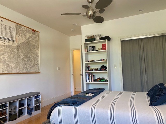 1793 Beacon Street, Unit 3 Brookline, MA 02445 - Photo 15 of 25 a bedroom with a bed and a book shelf