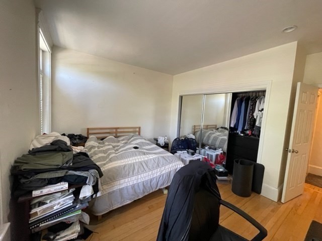 1793 Beacon Street, Unit 3 Brookline, MA 02445 - Photo 20 of 25 a bedroom with a bed and a mirror