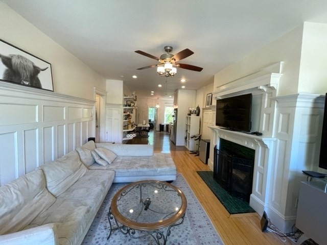 1793 Beacon Street, Unit 3 Brookline, MA 02445 - Photo 2 of 25 a living room with furniture a fireplace and a flat screen tv