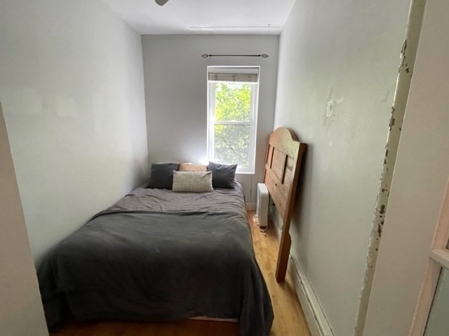 1793 Beacon Street, Unit 3 Brookline, MA 02445 - Photo 22 of 25 a bedroom with a bed and a window