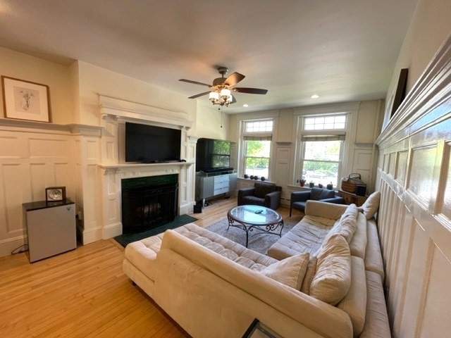 1793 Beacon Street, Unit 3 Brookline, MA 02445 - Photo 5 of 25 a living room with furniture a fireplace and a flat screen tv