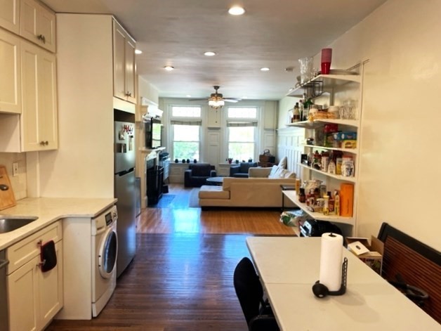 1793 Beacon Street, Unit 3 Brookline, MA 02445 - Photo 8 of 25 a living room with furniture and a kitchen view