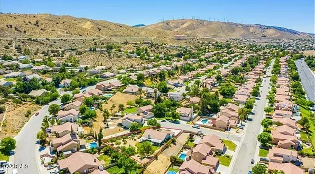 an aerial view of a house with a yard