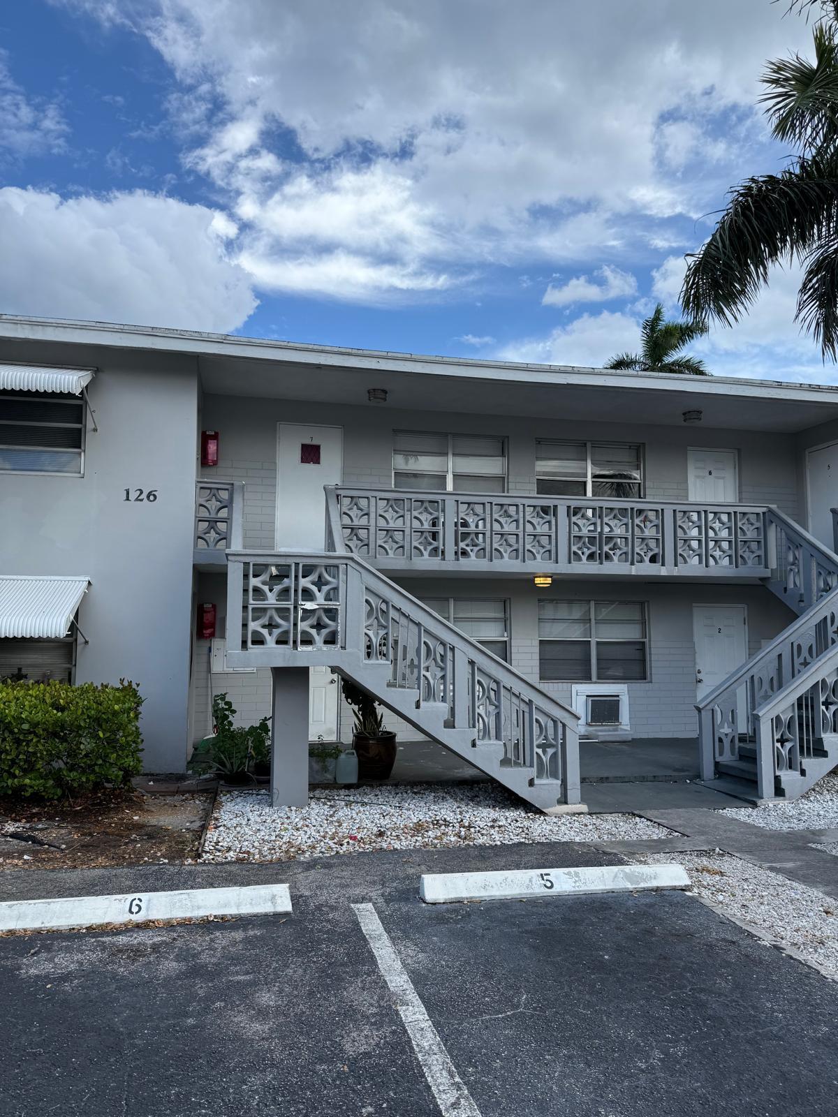 126 Cleveland Street, Unit 7 Lake Worth Beach, FL 33461 - Photo 1 of 24 a view of a street with a street