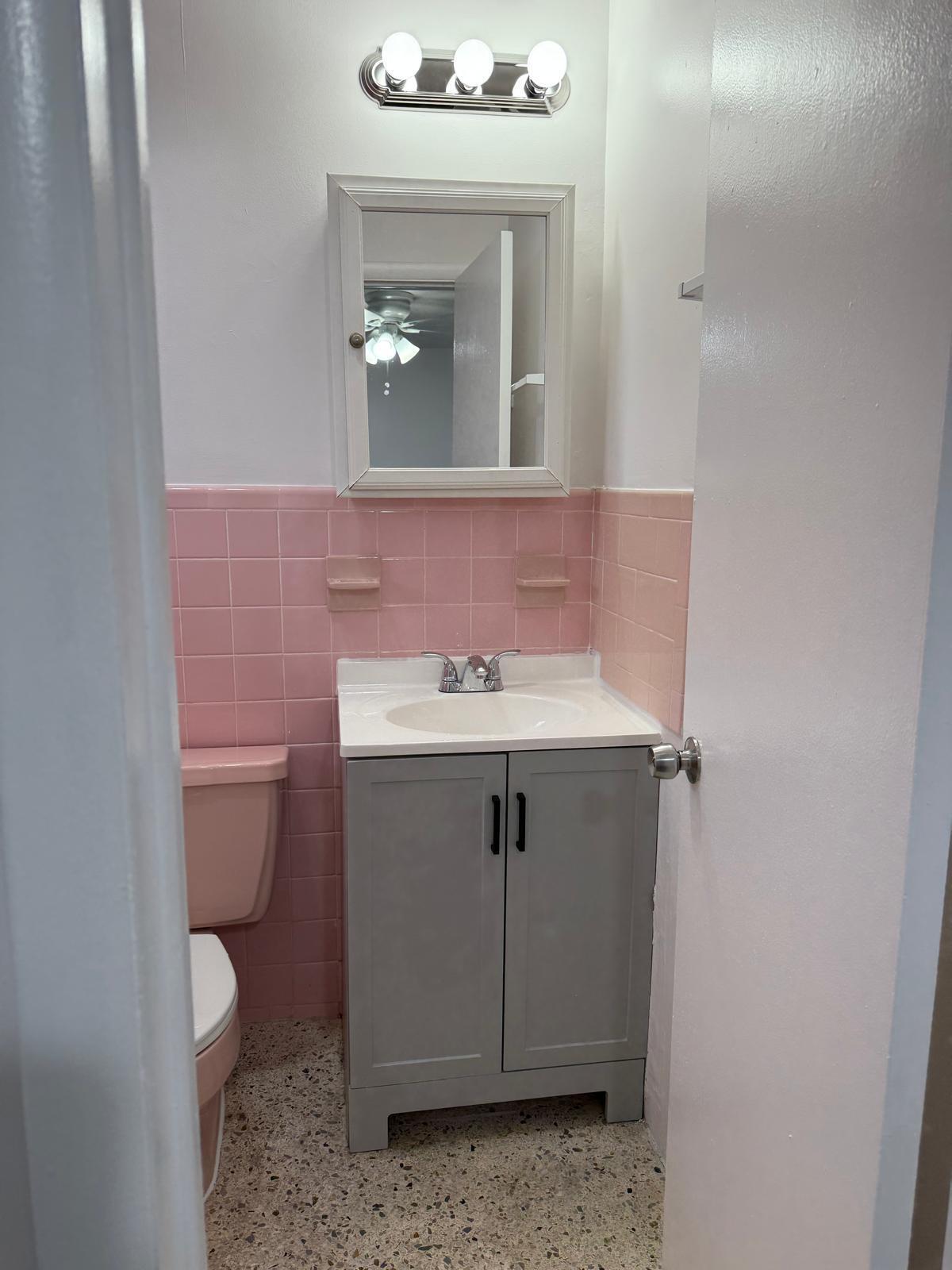 126 Cleveland Street, Unit 7 Lake Worth Beach, FL 33461 - Photo 15 of 24 a bathroom with a sink vanity and a toilet