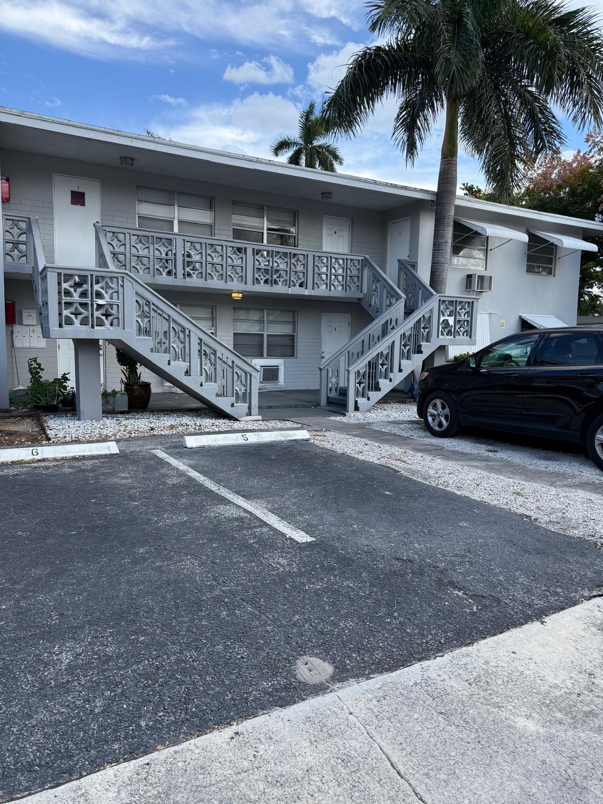 126 Cleveland Street, Unit 7 Lake Worth Beach, FL 33461 - Photo 23 of 24 a car parked in front of a building