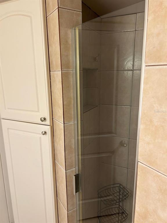 12760 Indian Rocks Road, Unit 1048 Largo, FL 33774 - Photo 13 of 24 a bathroom with a glass shower door