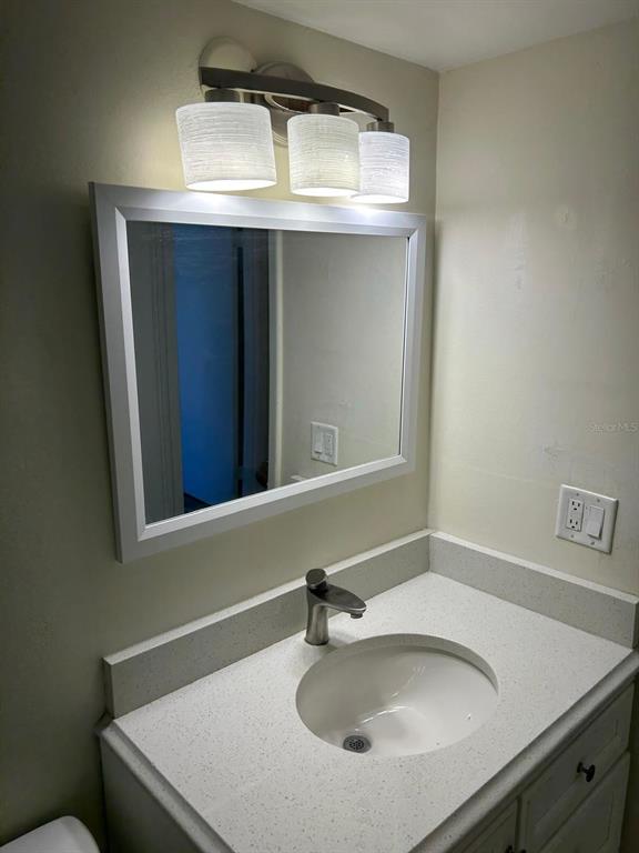 12760 Indian Rocks Road, Unit 1048 Largo, FL 33774 - Photo 15 of 24 a bathroom with a sink and a mirror