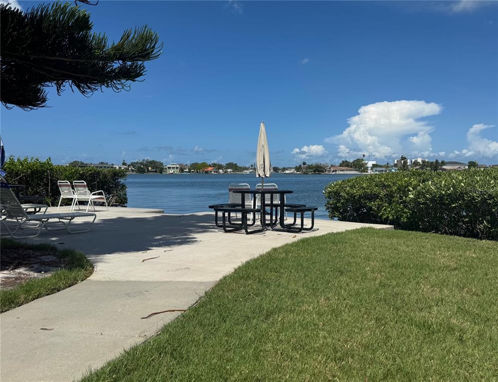 12760 Indian Rocks Road, Unit 1048 Largo, FL 33774 - Photo 20 of 24 a view of a terrace with a garden and a table