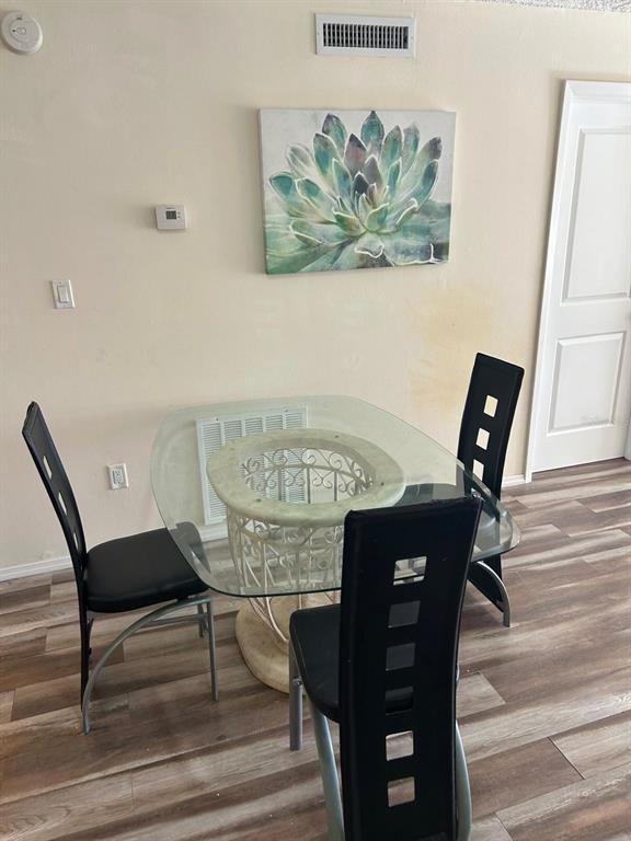 12760 Indian Rocks Road, Unit 1048 Largo, FL 33774 - Photo 6 of 24 a view of a dining room with furniture and wooden floor