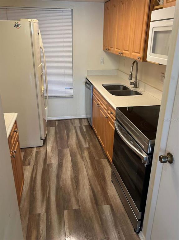 12760 Indian Rocks Road, Unit 1048 Largo, FL 33774 - Photo 8 of 24 a kitchen with a sink stainless steel appliances and cabinets