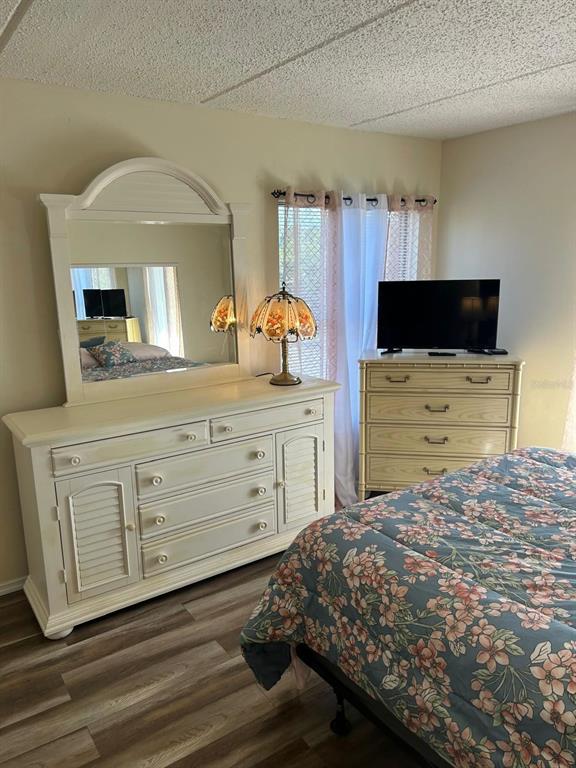12760 Indian Rocks Road, Unit 1048 Largo, FL 33774 - Photo 9 of 24 a bedroom with a bed and a mirror on dresser