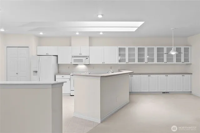 a kitchen with granite countertop white cabinets and a sink