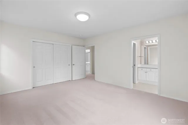 a view of an empty room and closet area
