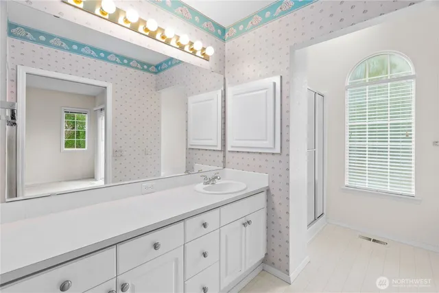 a bathroom with a sink and a mirror