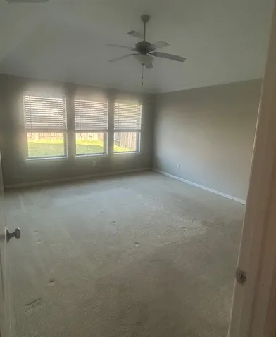 an empty room with a empty space and windows