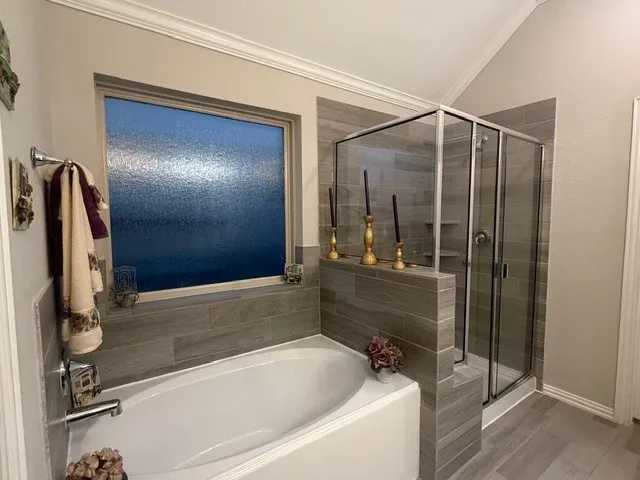 a bathroom with a shower and a tub
