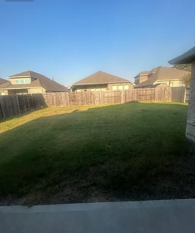 a view of yard with swimming pool and green space
