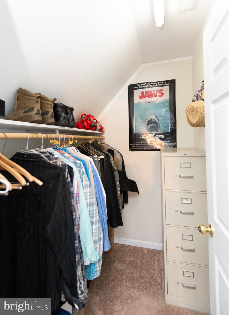 12136 Holly Road Ridgely, MD 21660 - Photo 57 of 136 a view of walk in closet with clothes and shoes