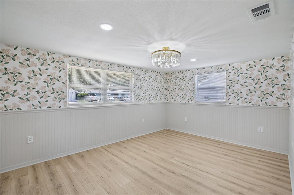 5753 10th Avenue New Port Richey, FL 34652 - Photo 22 of 46 a view of wooden floor in a white cabinet