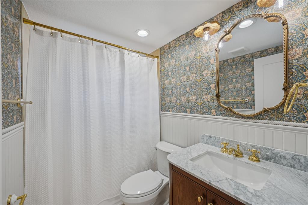 5753 10th Avenue New Port Richey, FL 34652 - Photo 25 of 46 a bathroom with a granite countertop sink and a mirror
