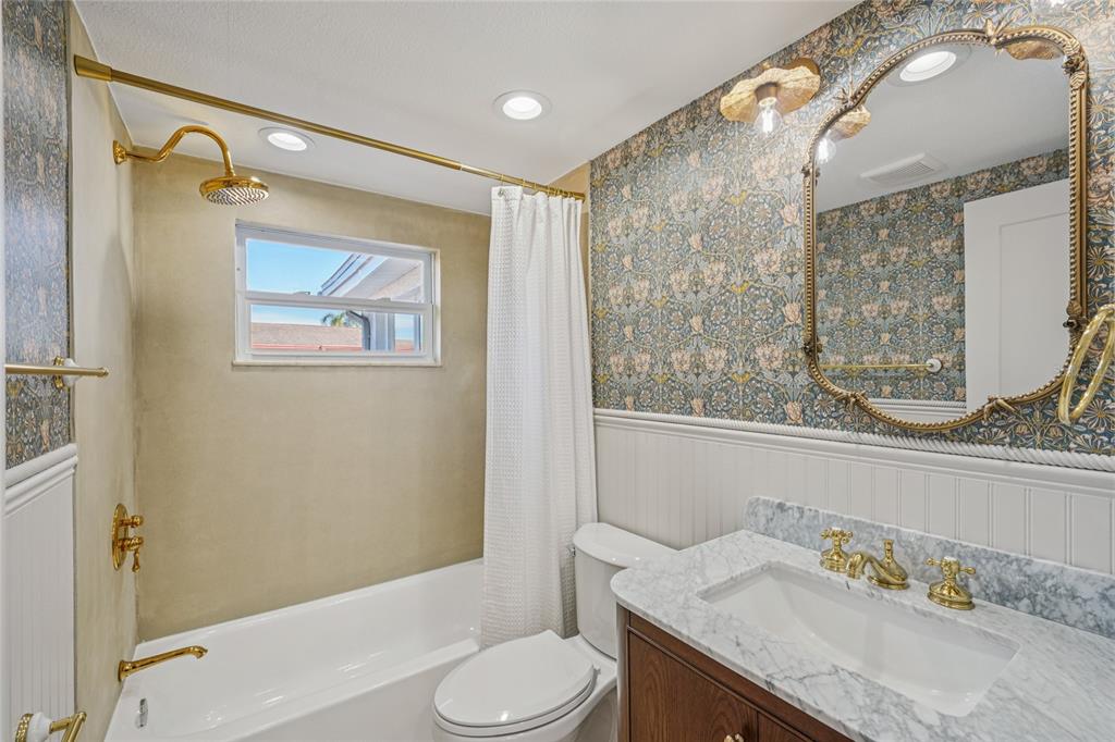 5753 10th Avenue New Port Richey, FL 34652 - Photo 26 of 46 a bathroom with a granite countertop sink toilet and shower