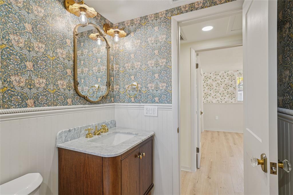 5753 10th Avenue New Port Richey, FL 34652 - Photo 27 of 46 a bathroom with a granite countertop sink a toilet and shower