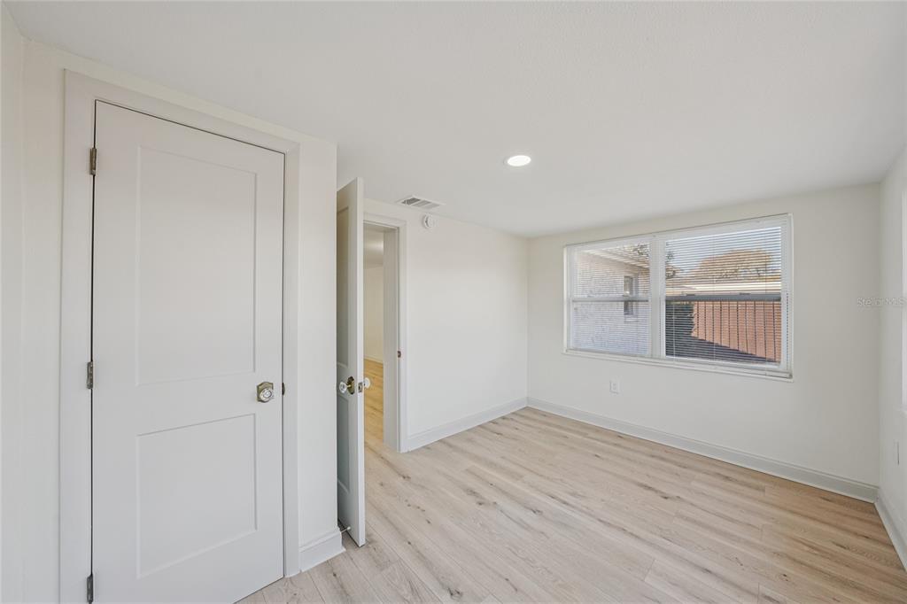 5753 10th Avenue New Port Richey, FL 34652 - Photo 35 of 46 a view of empty room with wooden floor and fan