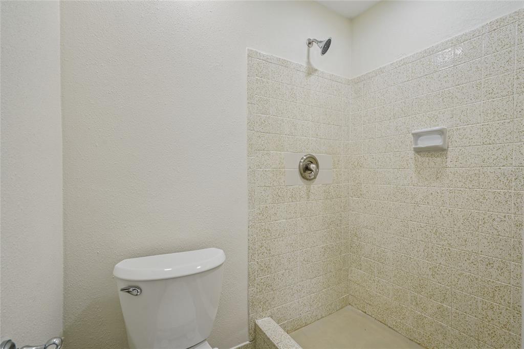 5753 10th Avenue New Port Richey, FL 34652 - Photo 38 of 46 a white toilet sitting next to a shower
