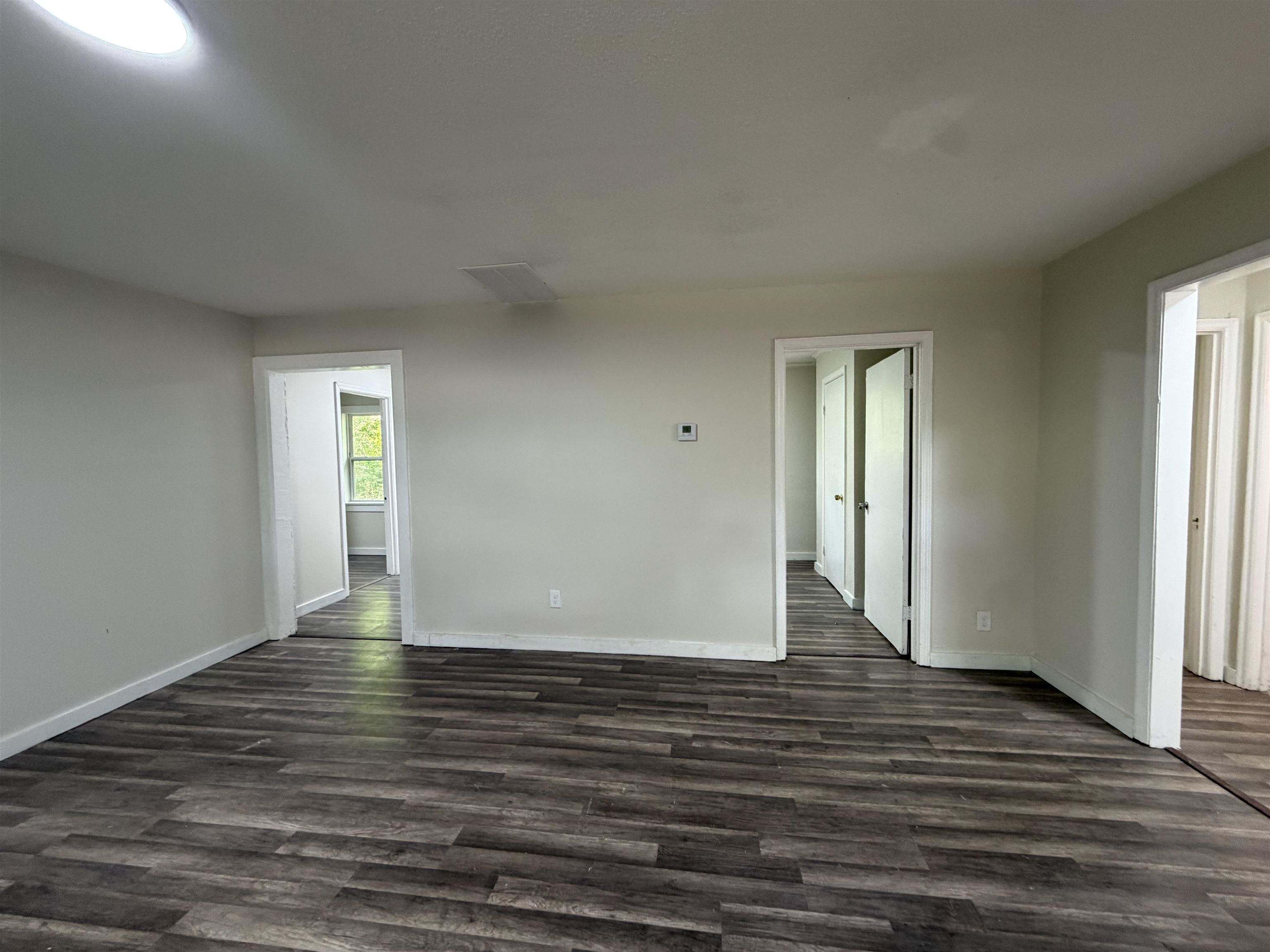 8 East Brooks Road Memphis, TN 38109 - Photo 16 of 16 a view of an empty room with window and wooden floor