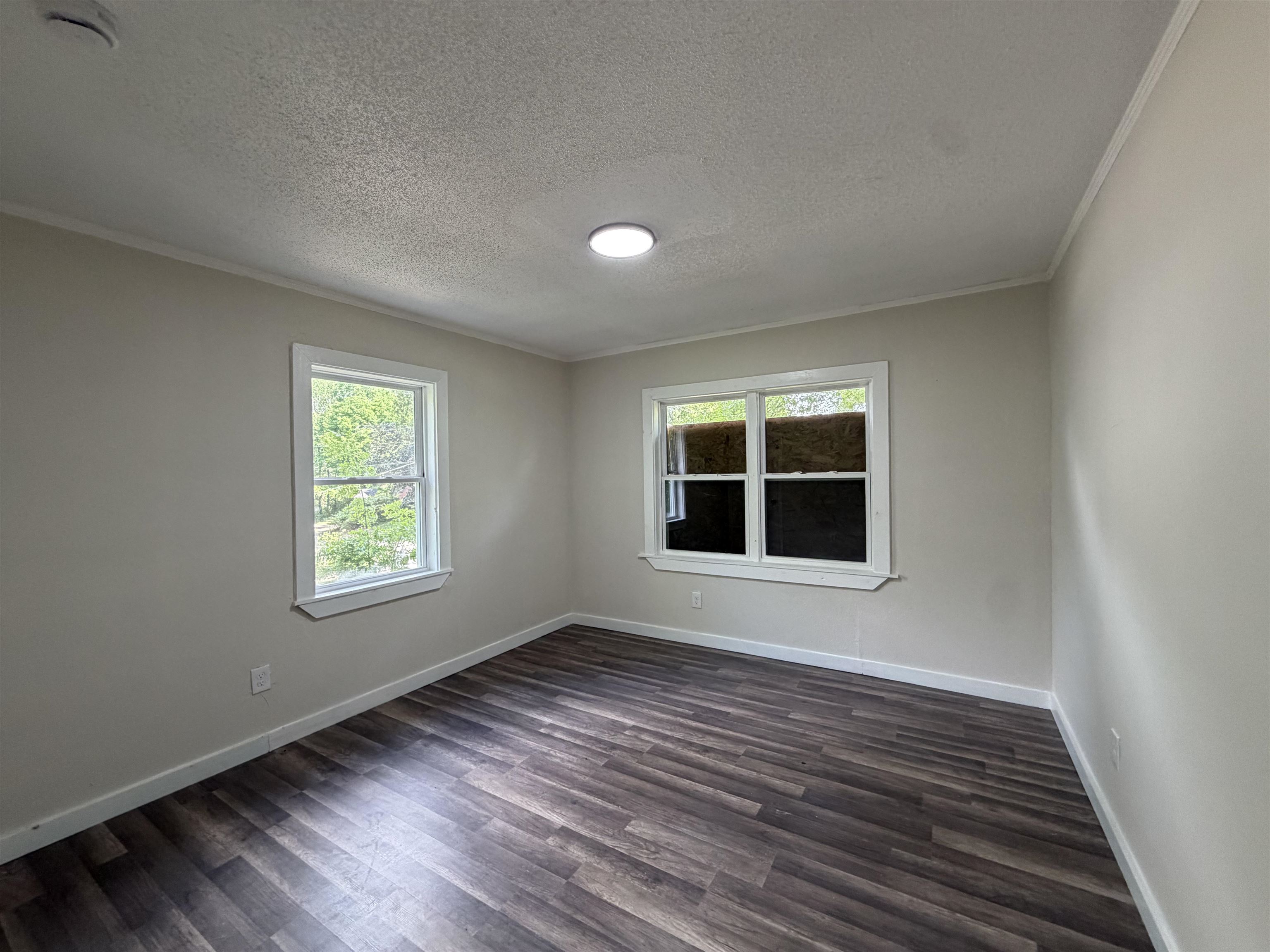 8 East Brooks Road Memphis, TN 38109 - Photo 9 of 16 a view of an empty room with wooden floor and a window