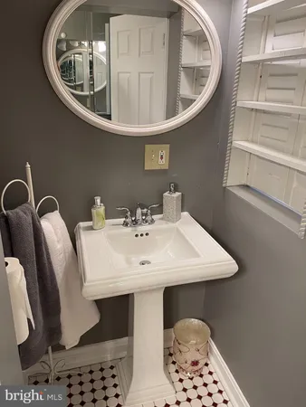 a bathroom with a toilet a sink and a window