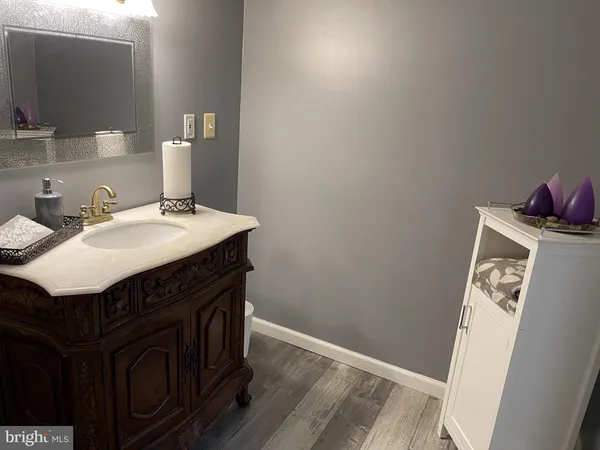 a utility room with wooden floor washer and dryer