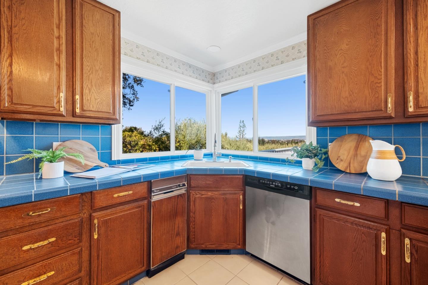 681 Upland Road Redwood City, CA 94062 - Photo 25 of 85 a kitchen with stainless steel appliances granite countertop wooden cabinets a sink and dishwasher
