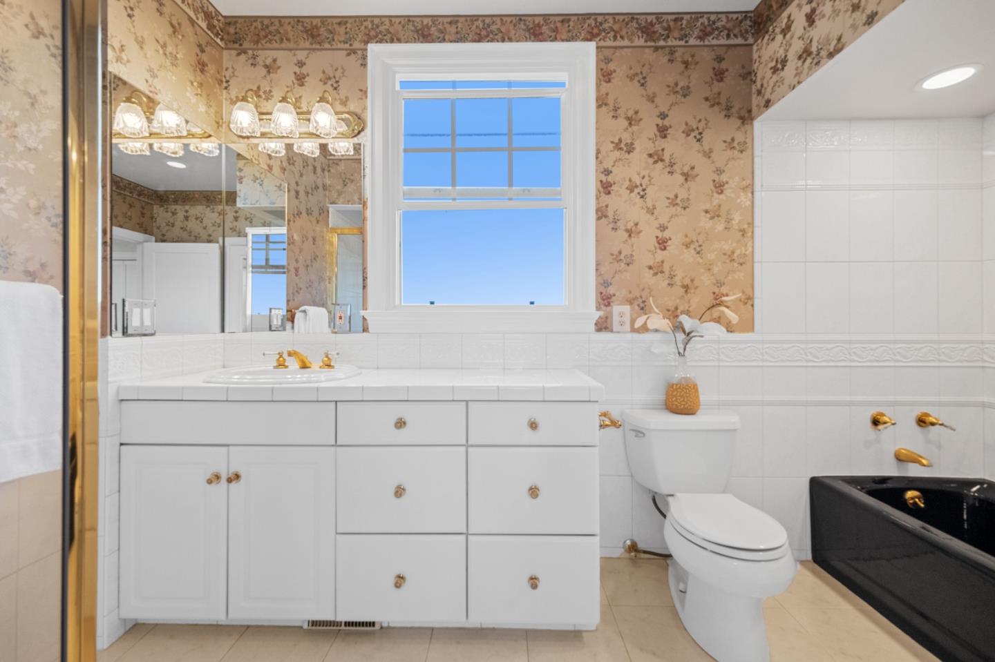 681 Upland Road Redwood City, CA 94062 - Photo 41 of 85 a bathroom with a sink vanity mirror and toilet