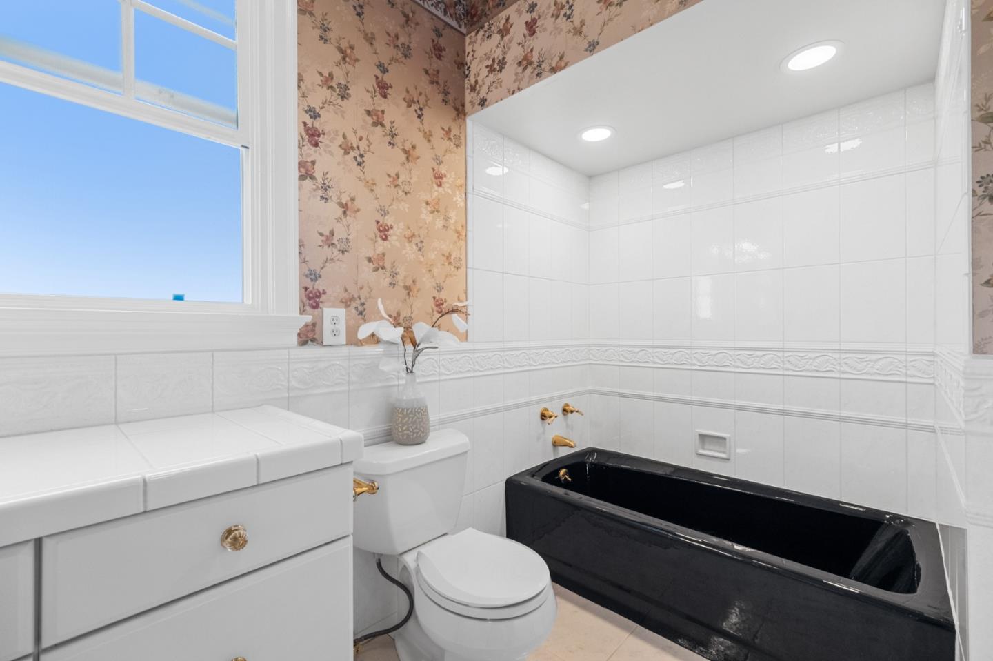 681 Upland Road Redwood City, CA 94062 - Photo 42 of 85 a bathroom with a sink a toilet and shower