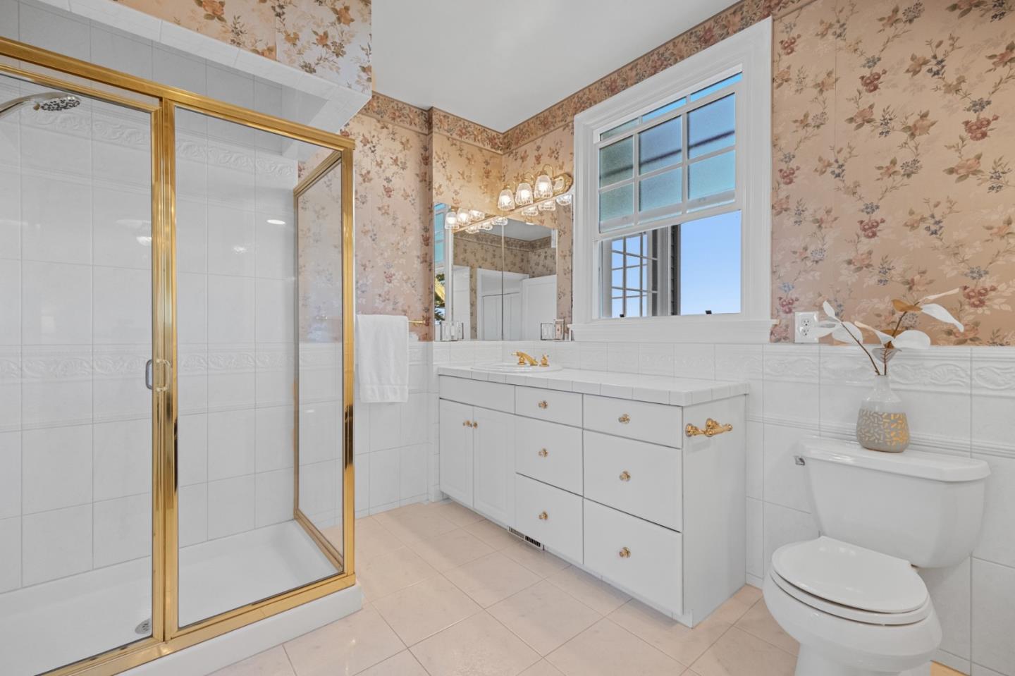 681 Upland Road Redwood City, CA 94062 - Photo 48 of 85 a bathroom with a granite countertop sink toilet a mirror a vanity and shower