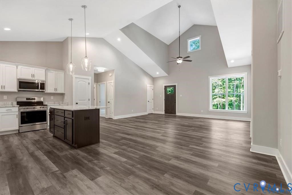 227 Oak Run Clarksville, VA 23927 - Photo 2 of 12 a kitchen with stainless steel appliances kitchen island granite countertop a stove a refrigerator and a wooden floors