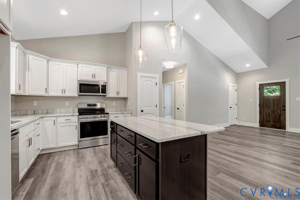 227 Oak Run Clarksville, VA 23927 - Photo 3 of 12 a kitchen with a sink dishwasher a stove top oven a refrigerator with white cabinets and wooden floor