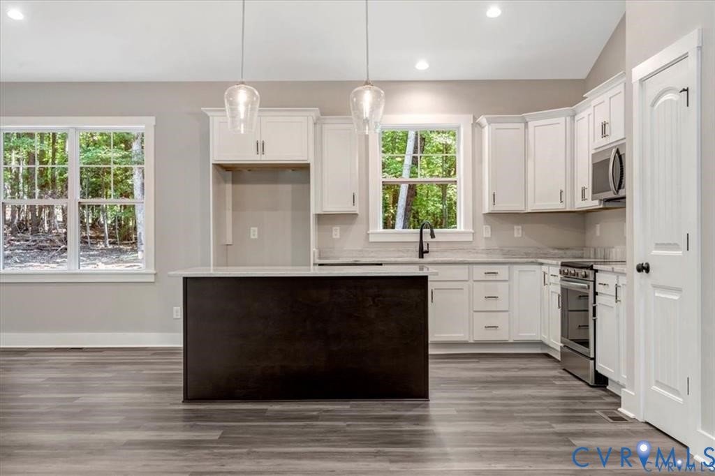 227 Oak Run Clarksville, VA 23927 - Photo 4 of 12 a kitchen with stainless steel appliances granite countertop a stove a sink and a microwave