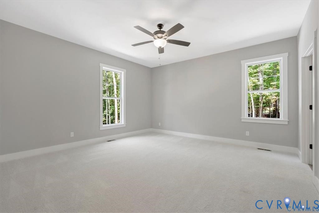 227 Oak Run Clarksville, VA 23927 - Photo 6 of 12 an empty room with windows and ceiling fan