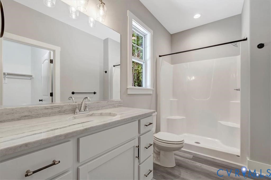 227 Oak Run Clarksville, VA 23927 - Photo 7 of 12 a bathroom with a granite countertop sink toilet and shower